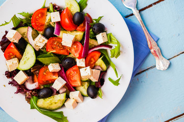 Greek salad on wooden background