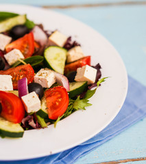 Greek salad on wooden background