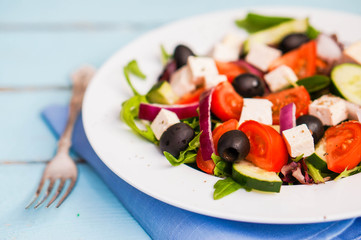 Greek salad on wooden background