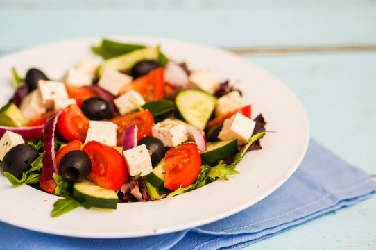Greek salad on wooden background