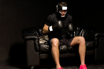 Boxer sitting on a couch getting ready for a fight