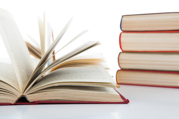 open books and stack of books on white