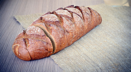 Fresh Tasty Bread on Woody Background