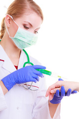 Hands of doctor nurse with syringe giving injection to patient