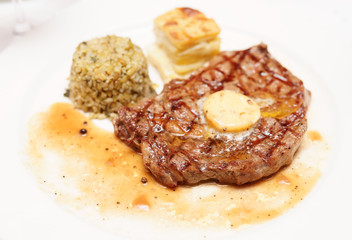 Rib eye steak with bulgur, butter and potato gratin