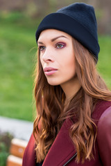 Young woman sitting on a bench.