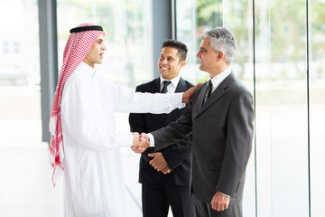 multicultural business partners handshaking