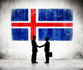 Two Businessmen Shaking Hands With Flag Of Iceland