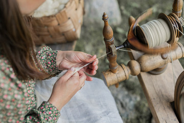 Hands of a woman traditional wool spinning.