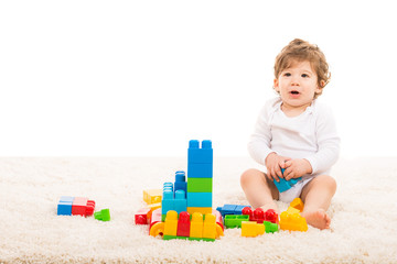 Happy boy playing with building blocks