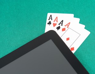 poker cards near digital tablet pc, concept of poker online