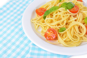 Delicious spaghetti with tomatoes on plate on table close-up