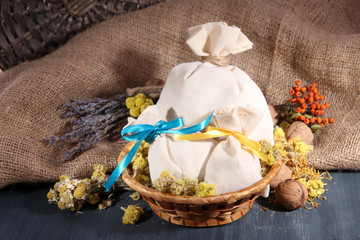 Textile sachet pouches with dried flowers, herbs and berries
