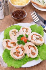 Delicious chicken roll on plate on table close-up