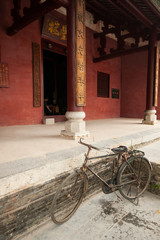 Fototapeta na wymiar Old bicycle parked in front of an ancient temple, China