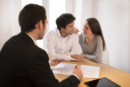 Young Couple meeting real-estate agent to buy property