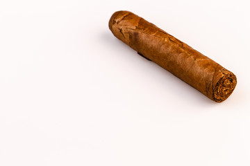 Expensive hand-rolled cigar on a while background