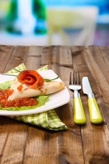 Pancake with red caviar, salmon and mayo, green onion,