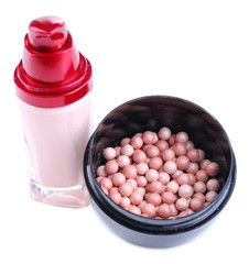 Powder balls and concealer isolated on white