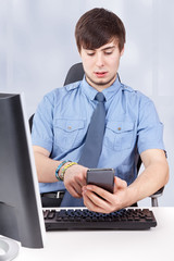 Young businessman calling by phone in the office