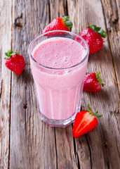Fresh milk, strawberry drink on wodeen table, assorted protein