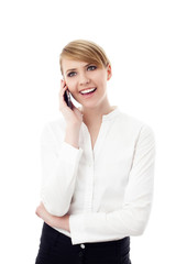 Happy young businesswoman talking on cellphone