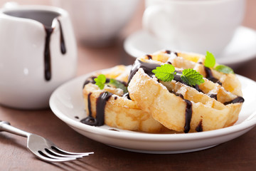 Belgian waffles with chocolate and powder sugar for breakfast
