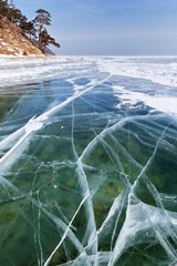 Transparent ice on Baikal Lake in winter sunny day