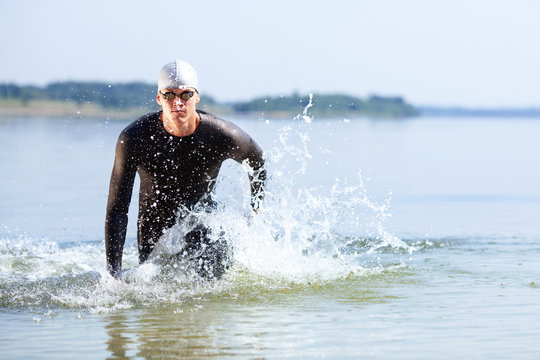 Triathlete Running Out Of The Water