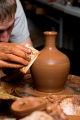 hands of a potter, creating an earthen jar
