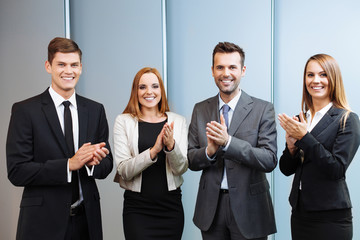 Group of happy business people clapping their hands