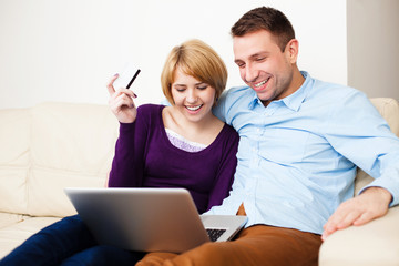 Young couple paying online with credit card