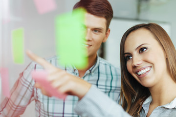 Obraz premium Two happy employees working together in the office