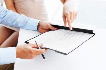 Two business people signing a document