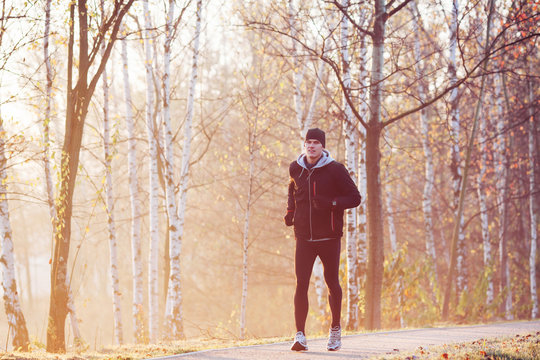 Man running at autumn morning