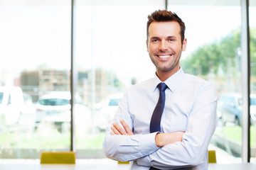 Happy young businessman in the office