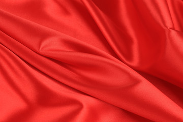 Fototapeta na wymiar Close up of red silk fabric background.