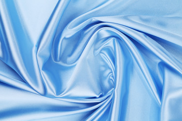 Close up of blue silk fabric background.
