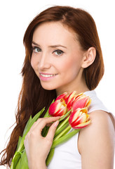 Young woman is holding bouquet of tulips