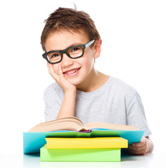 Little boy is reading a book