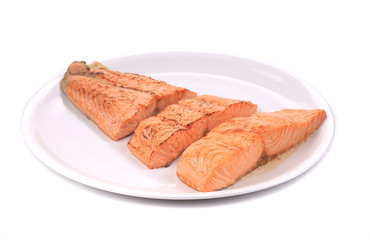 Slices of red fish fillet on plate.