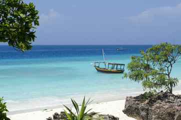 Beach and boat on turquoise water in Zanzibar, Tanzania, Africa - obrazy, fototapety, plakaty