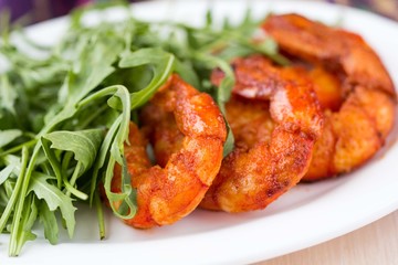 Fried spicy shrimp, prawn and salad of arugula, rukkola