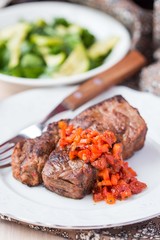 Grilled beef steak with salsa sauce dried tomatoes, red peppers