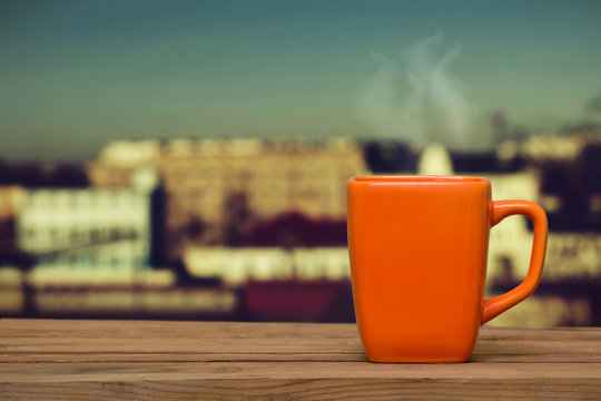 Steaming coffee on the window background.