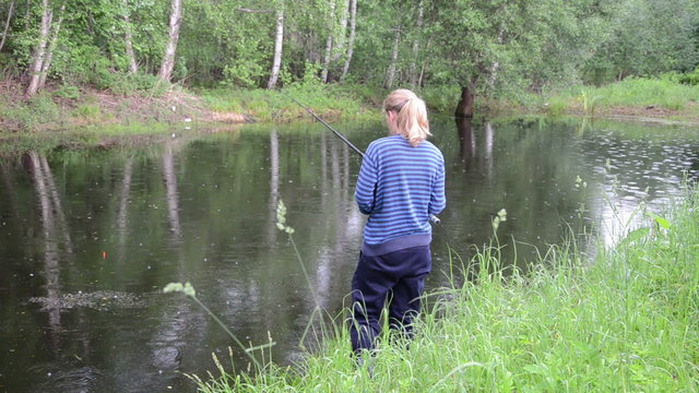 pond bounces ripples from the rain near the shore fishing woman