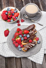 Chocolate eclairs with fresh berries