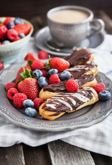 Chocolate eclairs with fresh berries