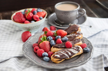 Chocolate eclairs with fresh berries