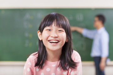happy pupils smiling in class with teacher